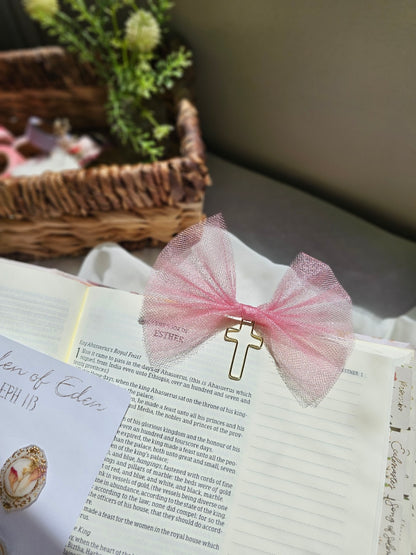 Shimmery Pink Tulle bookmark bow including a cross on an open book with a plant beside it and other stationery.