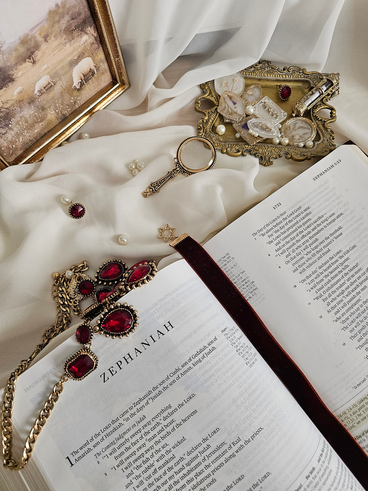 Burgundy ribbon with gold Star of David and Lion on either end sitting on an open Bible.