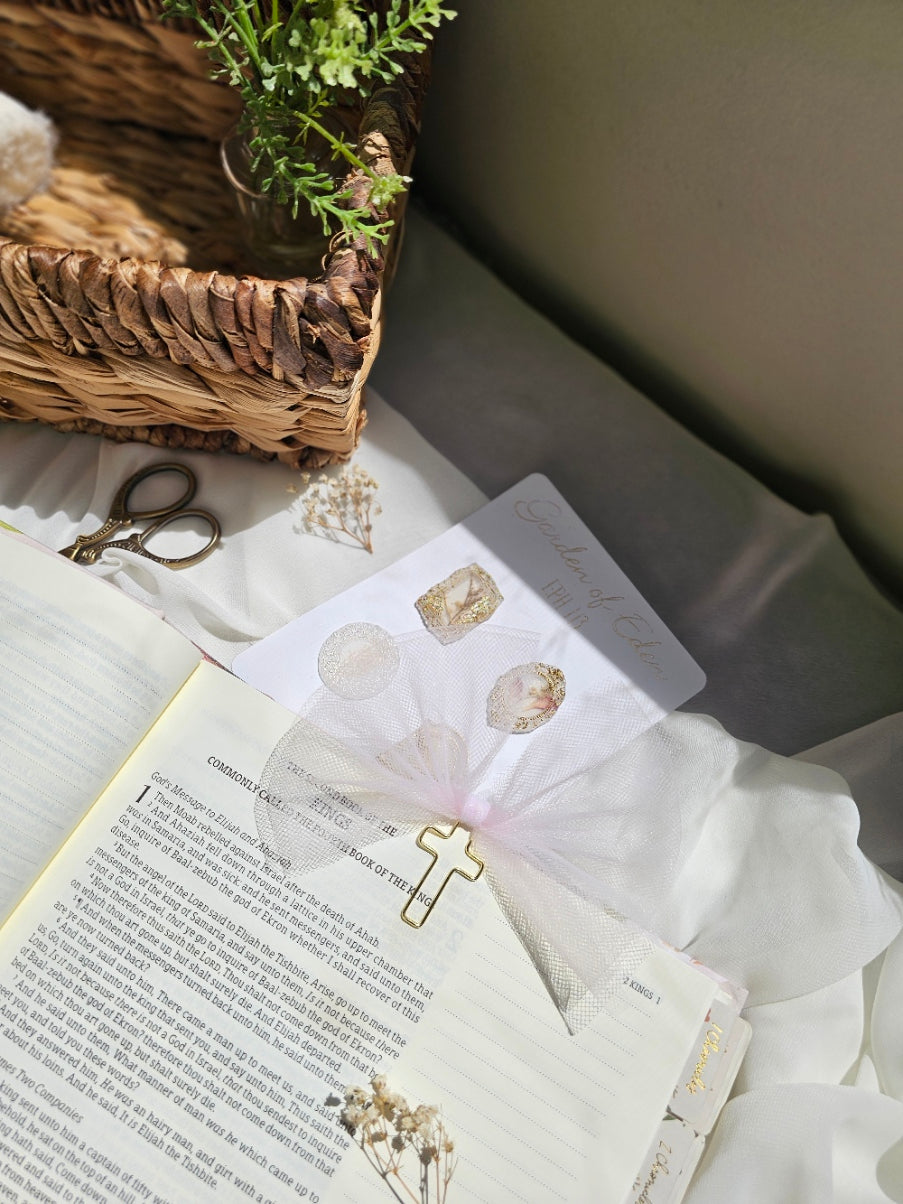 Light Pink Tulle bookmark bow including a cross on an open book with a plant beside it and other stationery.